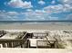 Wooden deck with steps leading to the sandy beach and ocean views at 328 S Waccamaw Dr., Garden City Beach, SC 29576