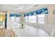 Bright dining room with beach view and a large white dining table with seating at 328 S Waccamaw Dr., Garden City Beach, SC 29576