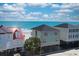 Coastal homes showcase vibrant exteriors and a beachfront view, perfect for seaside living at 328 S Waccamaw Dr., Garden City Beach, SC 29576