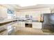 Well-lit kitchen with white cabinetry, modern appliances, and speckled countertop at 328 S Waccamaw Dr., Garden City Beach, SC 29576