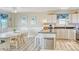 Bright kitchen featuring white cabinetry, granite countertops, and a charming breakfast nook at 328 S Waccamaw Dr., Garden City Beach, SC 29576