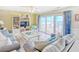 Cozy living room with ocean view, sliding glass doors, and comfortable seating area at 328 S Waccamaw Dr., Garden City Beach, SC 29576