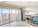 Open living room with sliding glass doors to a deck offering stunning ocean views at 328 S Waccamaw Dr., Garden City Beach, SC 29576