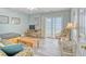 Relaxing living area with sleeper sofa, TV, and ocean views from the sliding glass doors at 328 S Waccamaw Dr., Garden City Beach, SC 29576