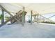 Spacious under house outdoor living space with stairs, beach access, and a peek of ocean views at 328 S Waccamaw Dr., Garden City Beach, SC 29576