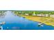 Aerial view featuring waterfront condos, a dock, and lake, marked with a locator pin on the roof at 4430 Turtle Ln. # 2-C, Little River, SC 29566