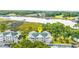 Aerial view of waterfront condos with a lake, a dock, and tree coverage, marked with a locator pin at 4430 Turtle Ln. # 2-C, Little River, SC 29566