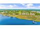 Scenic aerial view of waterfront condos with a river, a golf course, and a dock, marked with a locator pin at 4430 Turtle Ln. # 2-C, Little River, SC 29566