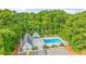 Aerial view of community pool area with lounge chairs, pristine landscaping, and ample parking at 4430 Turtle Ln. # 2-C, Little River, SC 29566