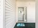 Charming condo entrance with decorative doormat, nautical-themed decor, and a white siding at 4430 Turtle Ln. # 2-C, Little River, SC 29566