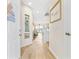 Bright hallway leading to the living area with beachy decorations, light wood flooring, and an open layout at 4430 Turtle Ln. # 2-C, Little River, SC 29566