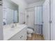 Well-lit bathroom with modern sink, toilet, and a shower/tub combination with blue patterned shower curtain at 9772 Leyland Dr. # 9772-9, Myrtle Beach, SC 29572