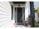 Inviting front door with a black door, wreath, and decorative accents at 981 Crystal Waterway Dr., Myrtle Beach, SC 29579