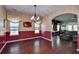 Dining room with hardwood floors, chandelier, and view of living area at 3149 Bramble Glen Dr., Myrtle Beach, SC 29579