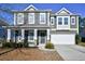 Two-story house with gray siding, stone accents, and a two-car garage at 3149 Bramble Glen Dr., Myrtle Beach, SC 29579