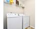 Bright laundry room with washer, dryer, and shelving at 3149 Bramble Glen Dr., Myrtle Beach, SC 29579