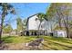 Home with raised foundation showing a spacious backyard, shed, and scenic landscaping at 5800 Creekside Dr., Myrtle Beach, SC 29588