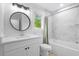 Bright bathroom featuring a new vanity, framed round mirror, and tub with shower at 5800 Creekside Dr., Myrtle Beach, SC 29588