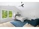 Cozy bedroom featuring a neutral color scheme, vaulted ceilings, and large windows with a backyard view at 5800 Creekside Dr., Myrtle Beach, SC 29588