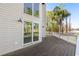 Expansive wooden deck accessible via sliding glass doors, surrounded by lush greenery at 5800 Creekside Dr., Myrtle Beach, SC 29588
