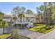 Gorgeous raised home with wrap-around deck, dual staircases, and lush landscaping at 5800 Creekside Dr., Myrtle Beach, SC 29588