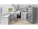Modern kitchen featuring stainless steel appliances, light gray cabinetry, quartz countertops and stylish backsplash at 5800 Creekside Dr., Myrtle Beach, SC 29588