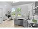 Open kitchen with stainless steel appliances, gray cabinets, and view to living area at 5800 Creekside Dr., Myrtle Beach, SC 29588