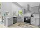 Modern kitchen featuring gray cabinetry, stainless steel appliances, and a window over the sink at 5800 Creekside Dr., Myrtle Beach, SC 29588