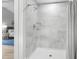 A tiled shower stall with glass doors, chrome fixtures, and an adjacent bedroom at 5800 Creekside Dr., Myrtle Beach, SC 29588