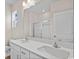 Bathroom featuring double sink vanity, quartz countertop, and walk-in shower at 3046 Deerberry Place, Longs, SC 29568