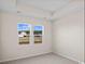 Bedroom featuring carpeted floors, tray ceiling, and bright windows overlooking the neighborhood at 3046 Deerberry Place, Longs, SC 29568