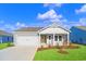 Charming single-story home with a manicured lawn, attached garage, and inviting front porch at 3046 Deerberry Place, Longs, SC 29568