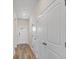 Hallway with wood-look flooring, white doors, and plenty of closet space at 3046 Deerberry Place, Longs, SC 29568