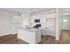 Modern kitchen featuring white cabinets, stainless steel appliances, and center island at 3046 Deerberry Place, Longs, SC 29568
