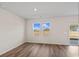 Well-lit living room featuring wood-look floors, light walls, and sliding glass door at 3046 Deerberry Place, Longs, SC 29568
