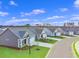 Street view showcases new homes with manicured lawns, driveways, and coordinated color schemes at 3046 Deerberry Place, Longs, SC 29568