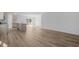 Bright, open-concept kitchen with stainless steel appliances and wood-look flooring leads to an open living area at 68 Cape Point Dr., Conway, SC 29527