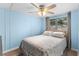 Inviting bedroom with a ceiling fan, light blue walls, and natural light from the double window at 6001-Mh107 S Kings Hwy., Myrtle Beach, SC 29575