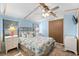Bedroom features a ceiling fan, closet, and natural light from two large windows at 6001-Mh107 S Kings Hwy., Myrtle Beach, SC 29575