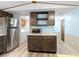 Bright kitchen with stainless steel refrigerator, microwave on countertop, and laundry closet access at 6001-Mh107 S Kings Hwy., Myrtle Beach, SC 29575