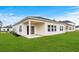 Backyard features a well-manicured lawn, covered patio, and view of the home's exterior at 7004 Watercress St, Myrtle Beach, SC 29579