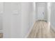 Hallway with wood-look floors, neutral walls, and visible switch plates at 7004 Watercress St, Myrtle Beach, SC 29579