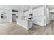 Modern kitchen boasts an island, quartz countertops, stainless steel appliances, and white cabinets at 7004 Watercress St, Myrtle Beach, SC 29579