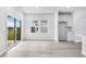 Bright living area, featuring white cabinets and wood look floors and access to the yard at 7004 Watercress St, Myrtle Beach, SC 29579