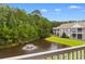 Balcony view overlooking a pond with fountain and trees in the distance at 1137 Peace Pipe Ln. # 201, Myrtle Beach, SC 29579