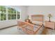 Bright bedroom with a light wood bed frame, matching nightstands, and a view of the trees outside at 1137 Peace Pipe Ln. # 201, Myrtle Beach, SC 29579
