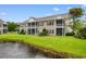 Backside view of condo building with screened patios and a tranquil pond view at 1137 Peace Pipe Ln. # 201, Myrtle Beach, SC 29579