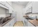Kitchen with stainless steel sink, white appliances, and light countertops at 1137 Peace Pipe Ln. # 201, Myrtle Beach, SC 29579