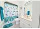 Cozy bathroom features a marine-themed shower curtain and accessories, as well as a white sink and cabinets at 3015 Old Bryan Dr. # 13-1, Myrtle Beach, SC 29577