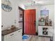 Bright entryway featuring a striking red door, beach-themed decor, and a stylish sideboard and bar cabinet at 3015 Old Bryan Dr. # 13-1, Myrtle Beach, SC 29577